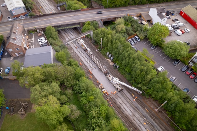 Warrington - Dallam Junction drone shot of track-mounted Kirow cranes lifting in track panels: Warrington - Dallam Junction drone shot of track-mounted Kirow cranes lifting in track panels
