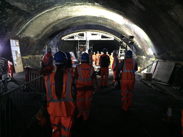 Visitors observing machinery used to carry out maintenance in the tunnel at Liverpool Central station