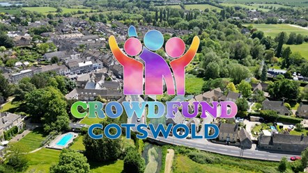 Aerial image of Fairford town with the Crowdfund Cotswold logo
