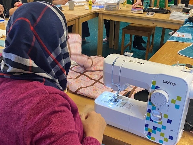 Afghan refugee Aziza sews an incubator cover for premature babies at a group run by Lancashire County Council’s Refugee Integration Team and local charity Roots to Branches.