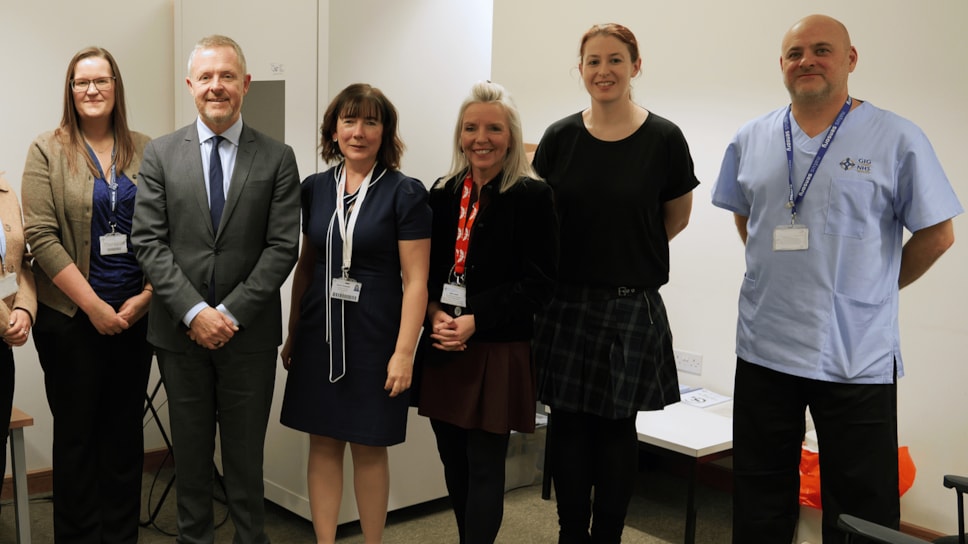 Cabinet Secretary for Health and Social Care with an audiologist and other staff at Clydach Primary Care Centre, Swansea