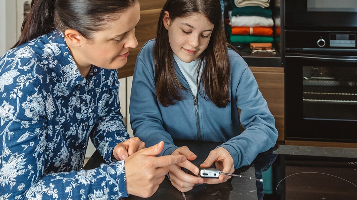 Woman and young girl holding a radio