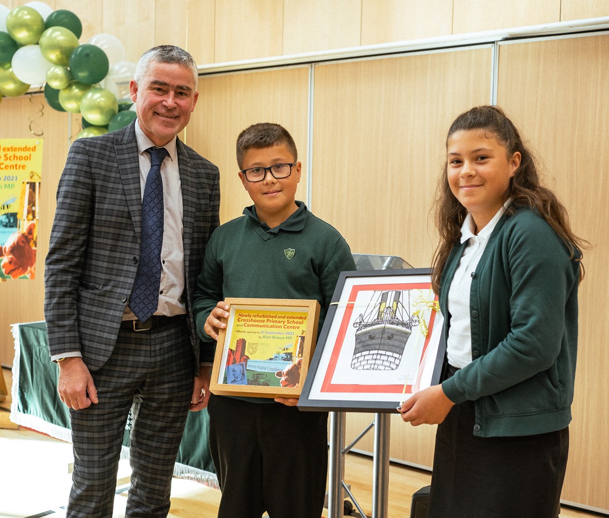 Nathan and Emma present gifts to Alan Brown MP