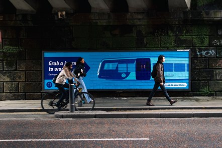 Image shows 'Try The Train' billboard on Manchester Oxford Road
