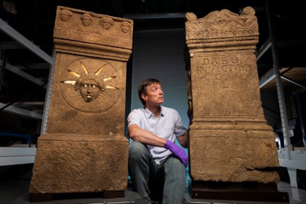Curator Dr Fraser Hunter examines the Roman altars.Photo © Duncan McGlynn (6)