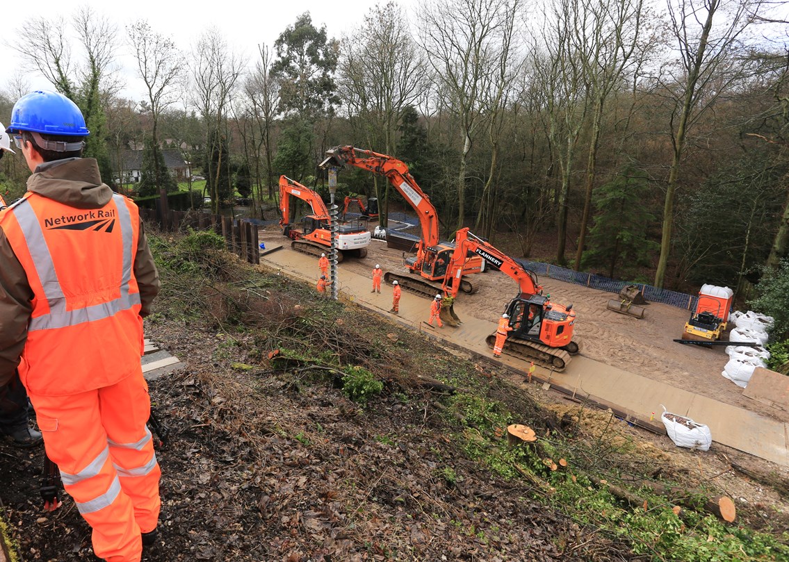 Network Rail reopens Dorking-Horsham railway five days ahead of schedule: Ockley landslip site, showing piling work