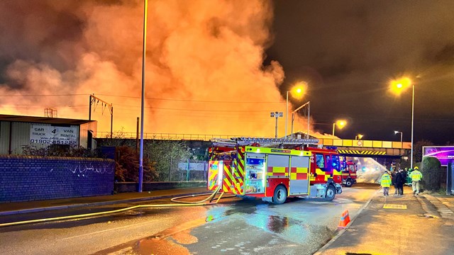 Huge warehouse fire causing rail delays through Wolverhampton: View from street during warehouse fire beside railway in Wolverhampton