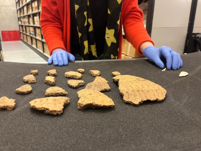 Pitty Close Farm finds: Kat Baxter, Leeds Museums and Galleries’ curator of archaeology, with some of the ancient Bronze Age finds made at Pitty Close Farm in Drighlington, Leeds.
As well as the cremated remains of a child and three adults, the dig uncovered fragments of a decorated clay urn, part of a pin which was carefully carved from a piece of animal bone and the shattered blade of a delicately honed flint knife.