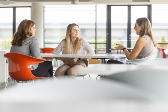 Apprentices talking in office