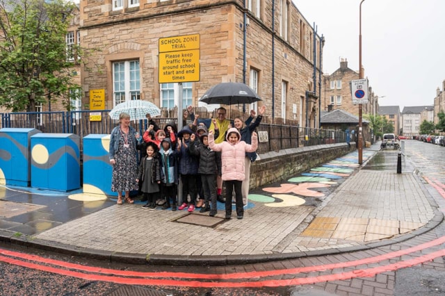 Dalry Primary School Zone 4: Cllr Scott Arthur, Transport & Environment Convener at City of Edinburgh Council; Karen McGregor, Scotland Director at Sustrans; Elaine Honeyman, Headteacher at Dalry Primary School pose with pupils by the new school zone