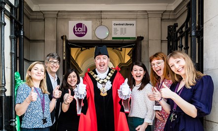 Mayor of Islington Cllr Troy Gallagher, centre, at the newly-reopened entrance of Central Library, with the Tall Stories team including its artistic director and co-founder Toby Mitchell.