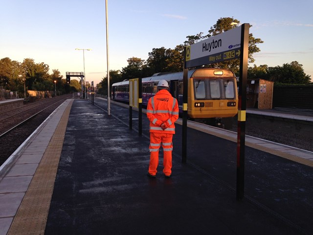 Network Rail is inviting local residents to a drop-in event to learn more about track work taking place between Huyton and Roby stations: First Train on new track at Huyton station with a member of Network Rail staff looking on