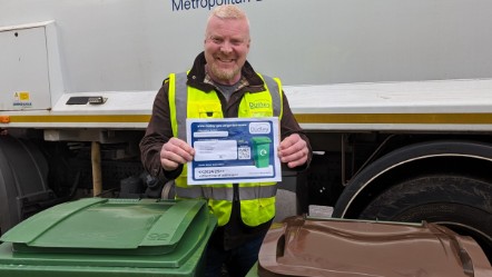 Cllr Damian Corfield holding one of the new garden waste permits