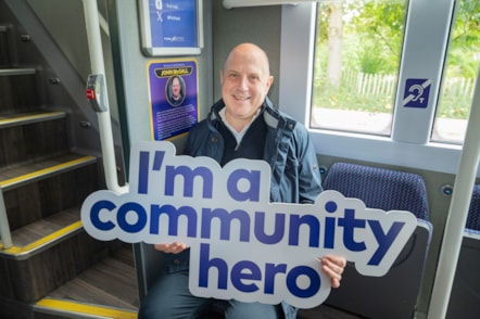 John McGall inside bus with plaque in his name