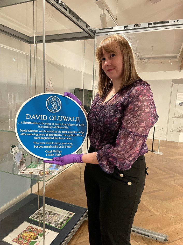 Overlooked: Preservative Party member Lauren Theweneti with the replica of David Oluwale's blue plaque, on display in Overlooked at Leeds City Museum.