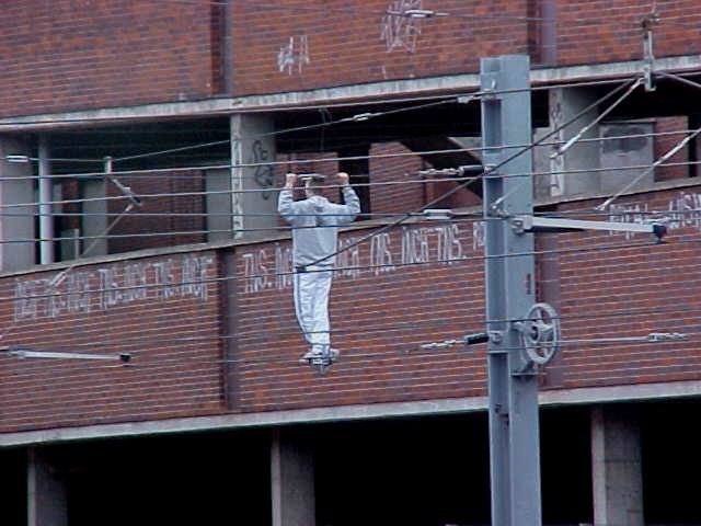 Youth balances between overhead lines in Sunderland. The power was turned off at the time: Youth balances between overhead lines in Sunderland.