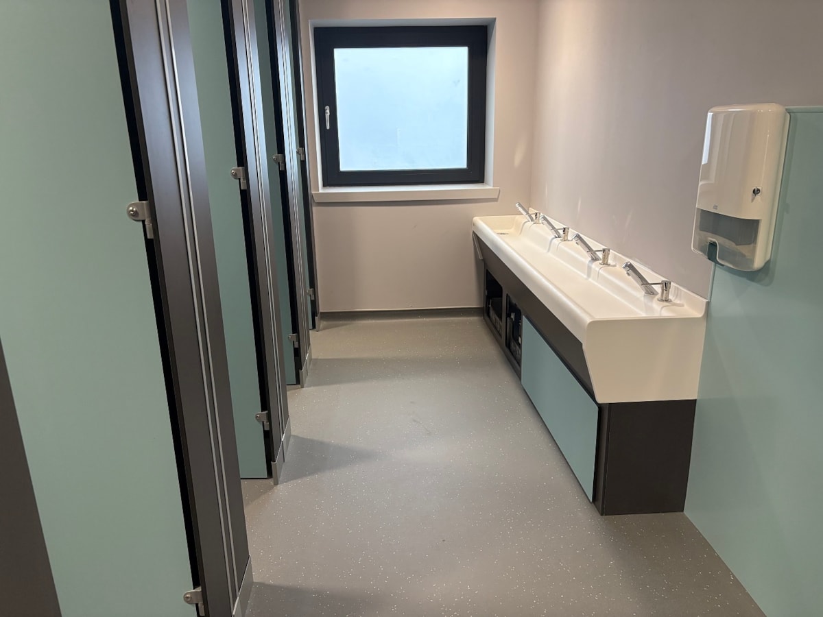 Refurbished pupil toilets at Cullen Primary School, featuring new sinks, cubicles and flooring.