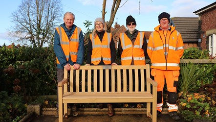 This image shows the poppleton memorial bench alongside station volunteers