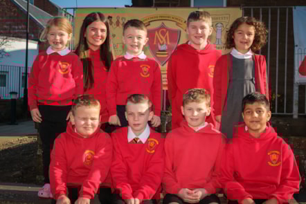 Children and young people from Mauchline Primary and ECC celebrate their HMIE report