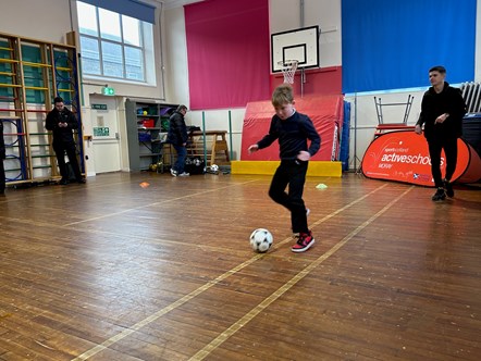 Jags midfielder, Marcus Goodall, watching P6 Kade Beaman's leg work. He went for a kick around with school pupils ahead of his club’s Scottish Cup game on Sunday (21 January) against Celtic.