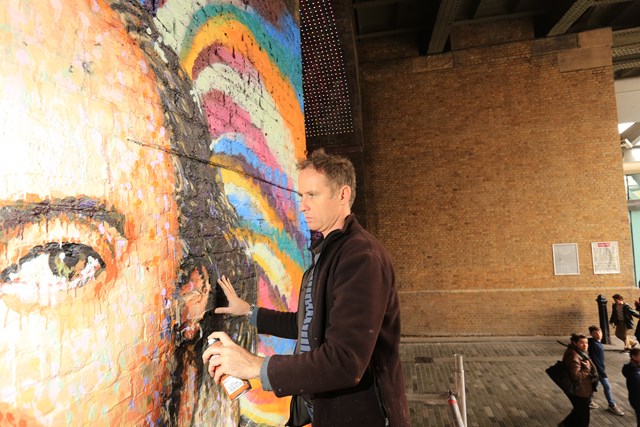 Jimmy C working: Street artist Jimmy C works on a portrait of William Shakespeare on a Network Rail wall in Southwark