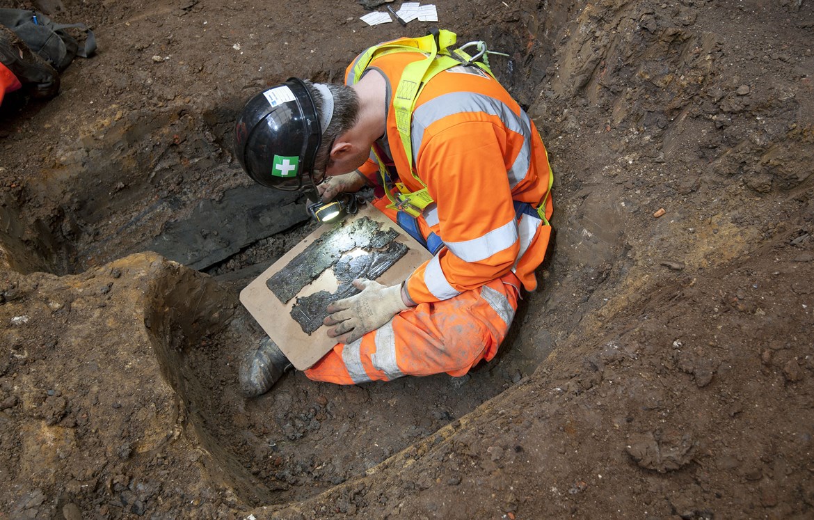 HS2 archaeologists seek citizen scientists to unlock the forgotten stories of St James’s Burial Ground: An archaeologist examines at coffin plate at St James's November 2018