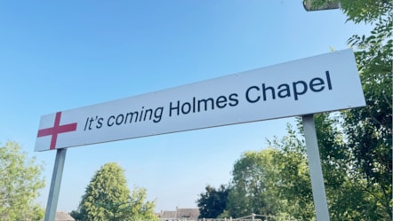 IT'S COMING HOLMES CHAPEL station sign