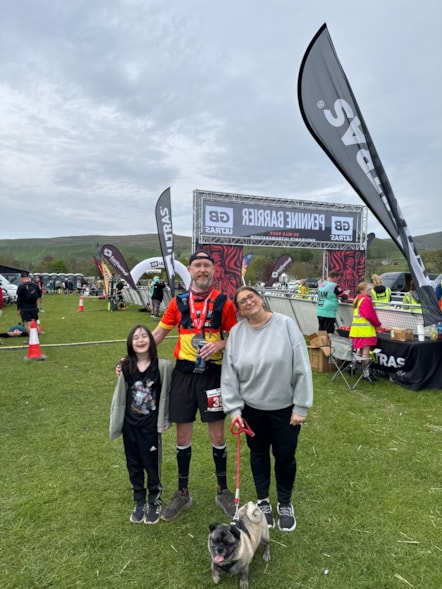 Jason Lawlor with his family at the finish line of the ultra-marathon