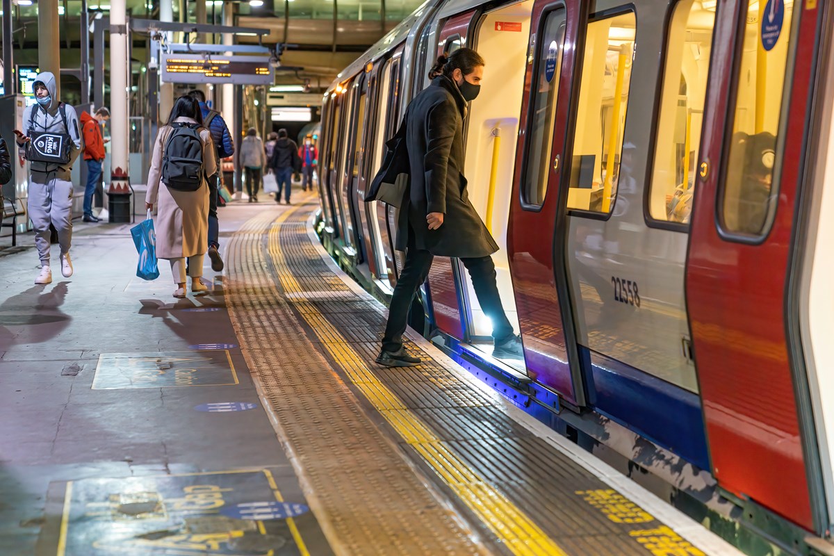 Man with mask entering Tube