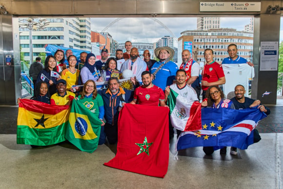 TfL prepares for surge in late-night travel as world-class events draw millions across London: TfL Image - Transport staff from World Cup competing nations gather at Wembley Park Tube station ahead of a busy summer of late night travel (2)
