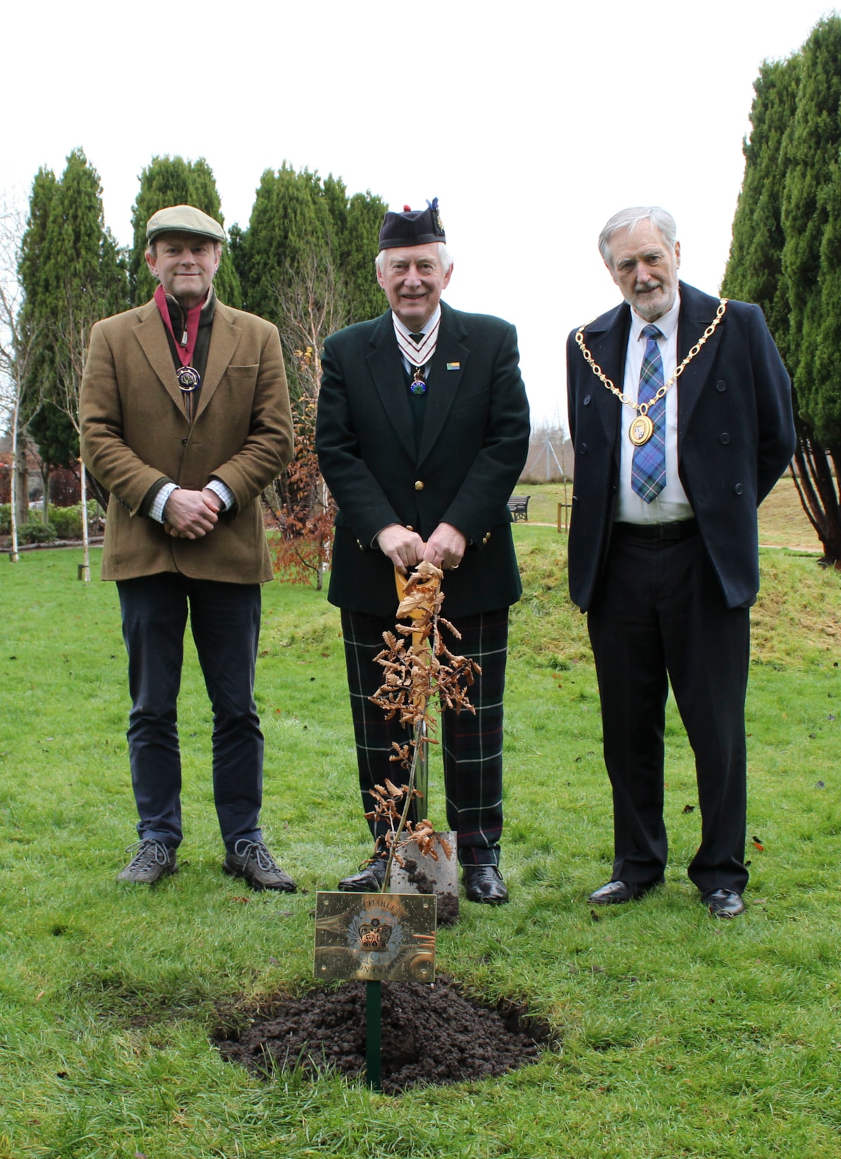 Earl of Moray, John Stuart; Lord Lieutenant of Moray Major General Seymour Monro; Moray Council Civic Leader, Cllr John Cowe take part in the planting of a local sapling to commemorate the coronation of King Charles III.