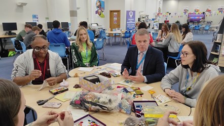 Minister for Education and Welsh Language talking to learners at Coleg Cambria