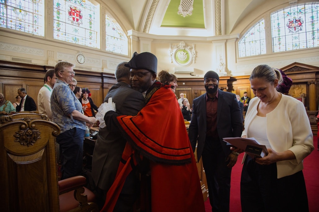 Departing Mayor Cllr Jackson hugs colleagues as he leaves the Council Chamber