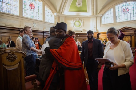 Departing Mayor Cllr Jackson hugs colleagues as he leaves the Council Chamber