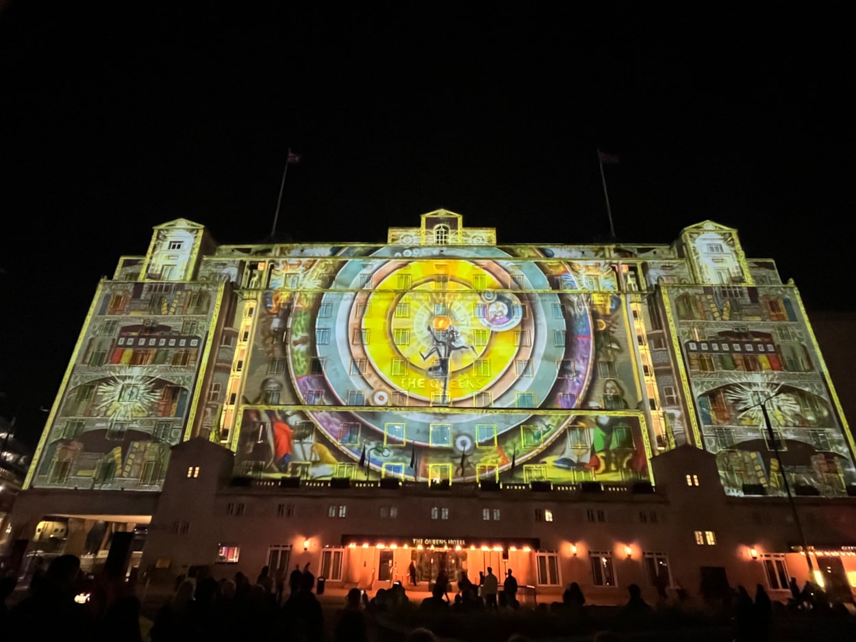 Light Night 2024: At The Queens Hotel The BookBinder saw a fairy tale figure lead a cast of birds, beasts and boats, in an impressive projection across the iconic hotel’s façade.
A collaboration with the British Library and created by artists Illuminos,  the piece is inspired by British Library’s Flickr Commons collection which includes fantastical drawings, prints and images.