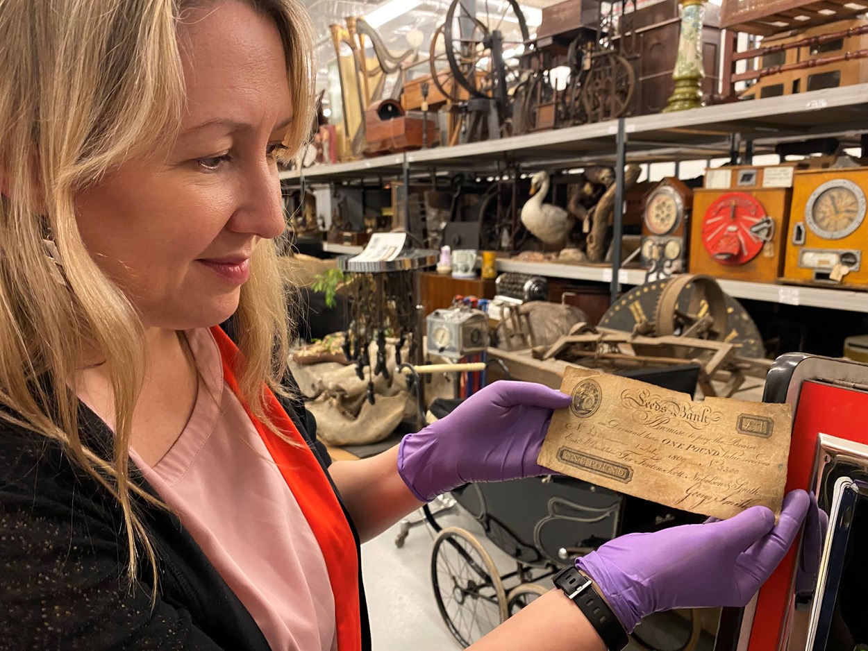 Money Talks: Kat Baxter, Leeds Museums and Galleries’ curator of archaeology and numismatics with one of the local bank notes carrying the branding of both the city itself and now defunct local banking institutions like The Leeds Bank, Leeds Union Bank and Leeds Commercial Bank.