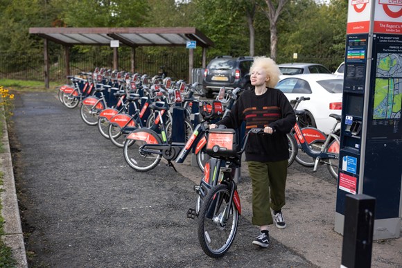 TfL Press Release - Docked e-bikes now available for hire as part of London’s record-breaking Santander Cycles scheme: TfL Image - A person (they/them) using a Santander Cycles e-bike