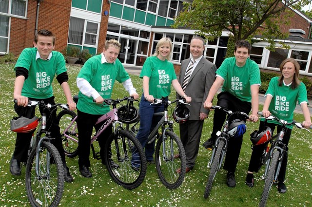 NETWORK RAIL GETS ON ITS BIKE FOR CHARITY THIS SUMMER: Network Rail's head of corporate responsibility Jerry Swift and BBC weather presenter Carol Kirkwood with pupils from Princes Risborough School
