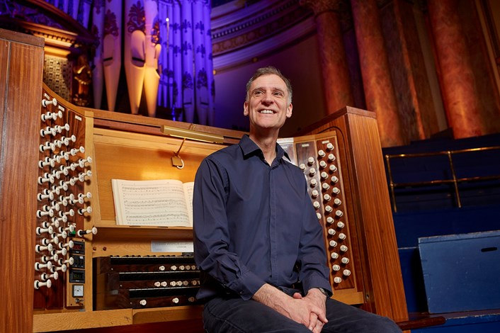 Leeds Town Hall organ recital: Leeds City Organist, Darius Battiwalla with the Leeds Town Hall organ. Credit Justin Slee.