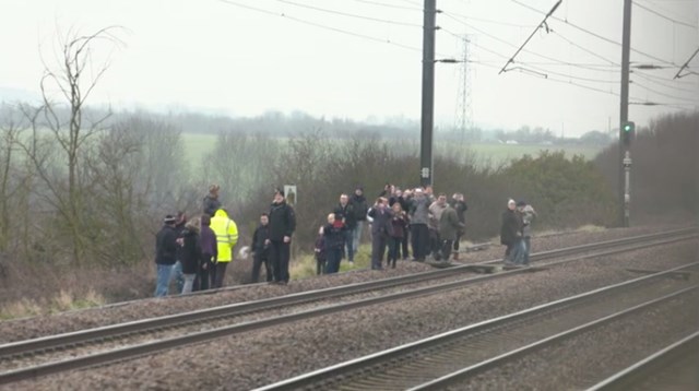 Crowds stand on the East Coast Main Line, forcing the Flying Scotsman and all other train services to stop in 2016