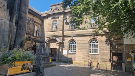 Lancaster library building is light stone in colour with large white framed windows and two bikes outside