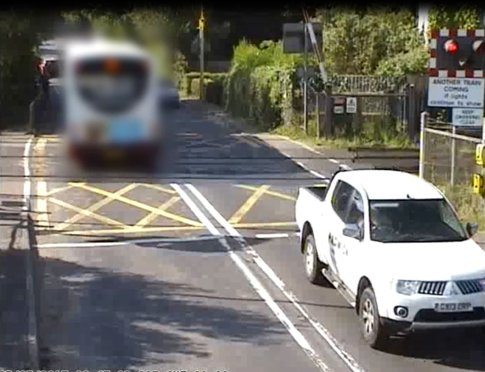 Yapton - level crossing: A bus races the red lights at Yapton level crossing, Sussex, and gets nabbed by the red light cam