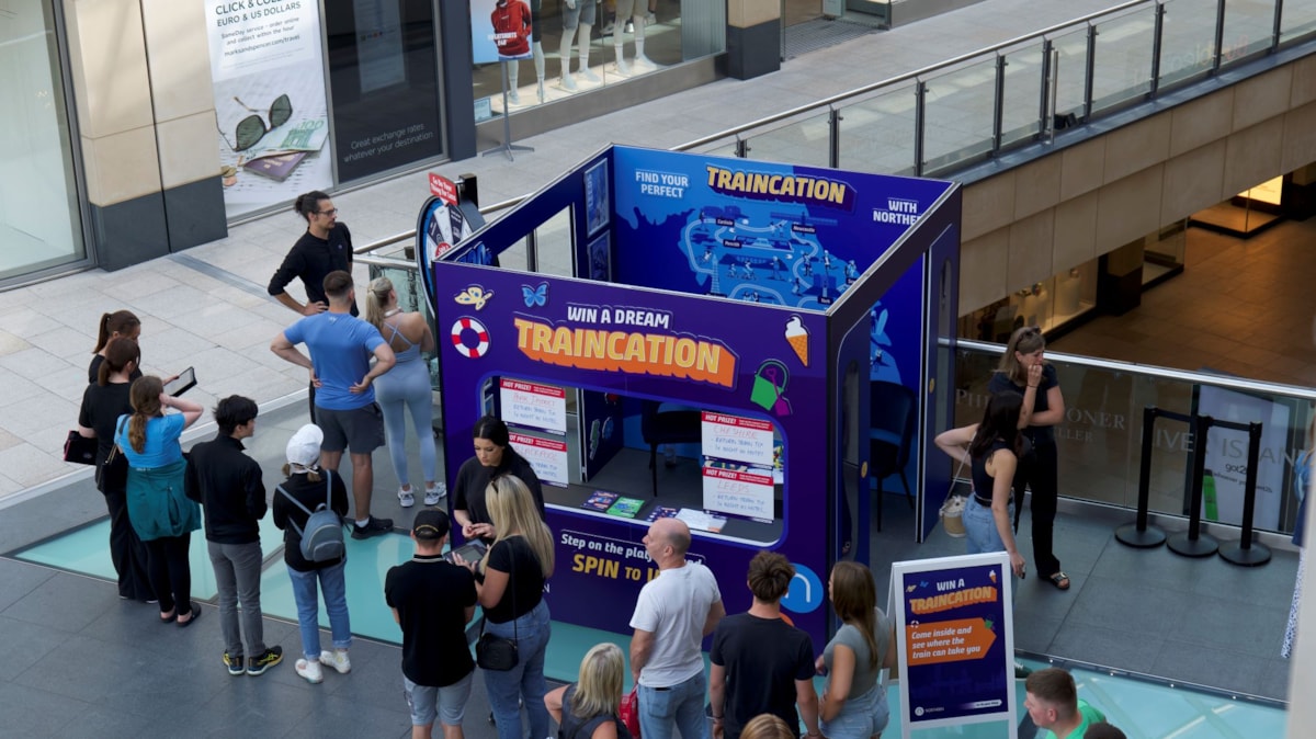 Image shows pop-up travel agency at Trinity Leeds promoting Traincations-2