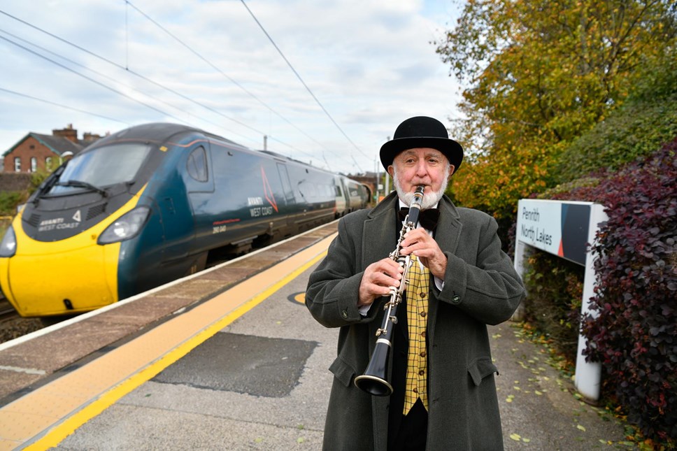 Philip Lowe performs music with his clarinet on the platforms at Penrith station