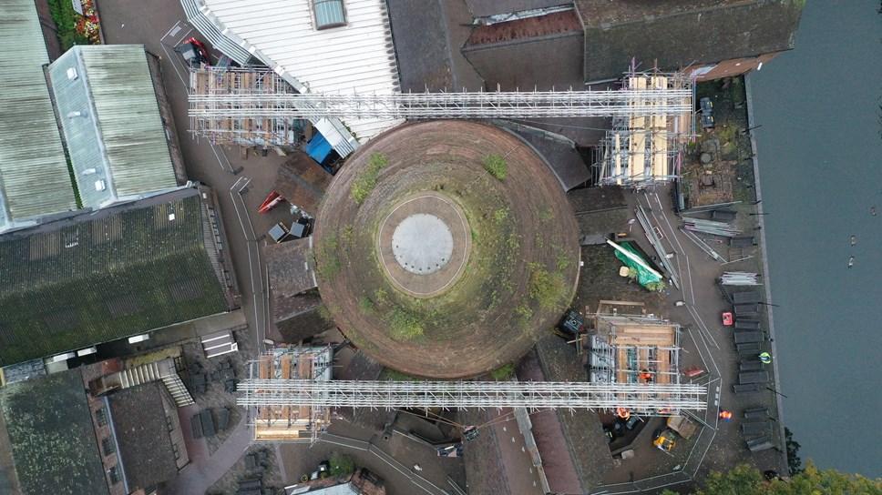 Aerial shot of scaffolding being lowered into place at the Red House Glass Cone