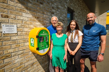 Laura's parents Nora and James Henderson, her brother Daren and her niece Leah viewing the new defib at the William McIlvanney Campus