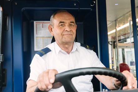 A bus driver behind the wheel of a bus in Brighton