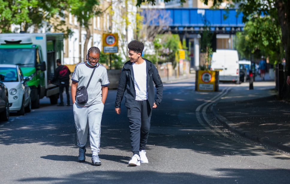 Two people walking along Richmond Road in Hackney - credit Gary Manhine