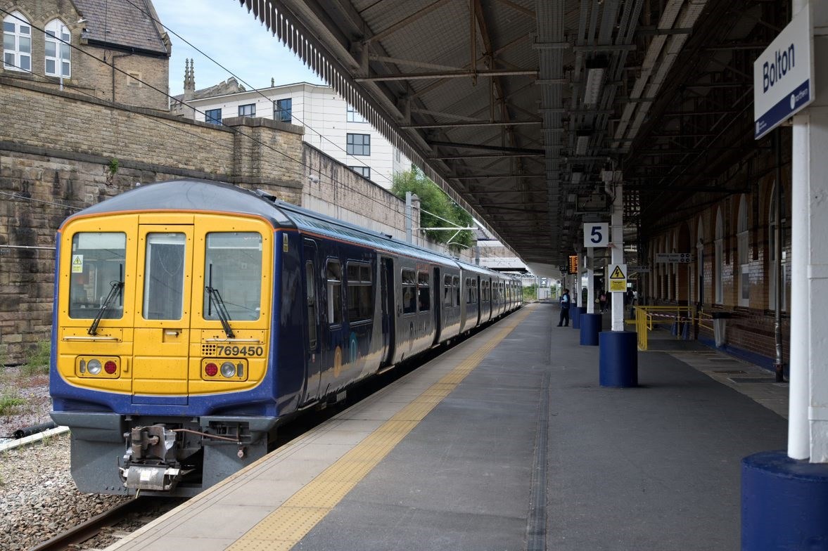 A Northern train waits at Bolton station