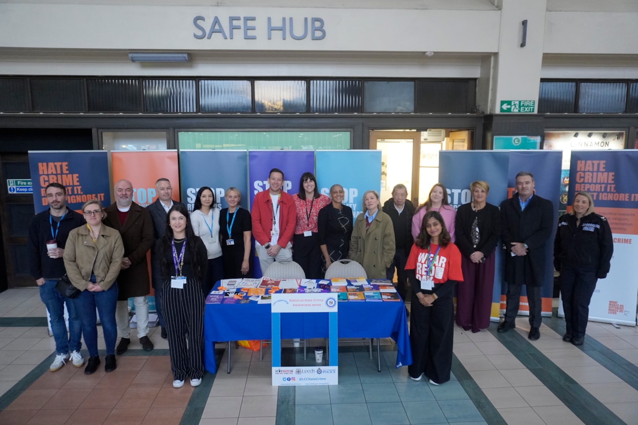 Hate Crime Awareness Week group photo: Members of the Safer Leeds partnership outside of the Safe Hub at Leeds Station